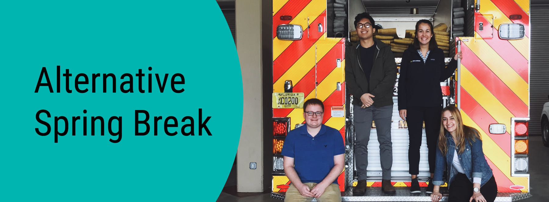 Alternative Spring Break. Students standing on the back of a fire engine.