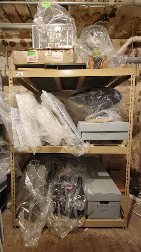A shelving unit full of materials from the Argus Museum