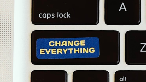 A laptop keyboard with a Change Everything sticker over the shift key