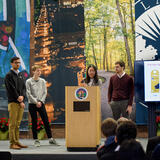 four students at a podium