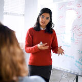 A student teaching at a white board