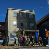students in front of a shipping container library building