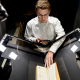 A UMSI student digitally scanning a book