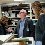 An industry professional speaking to UMSI students in an archive