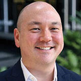 A headshot of Rodger Devine
