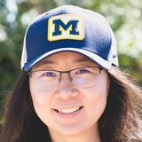 A headshot of Kaiwen Sun wearing a University of Michigan hat