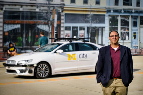 man standing beside a car