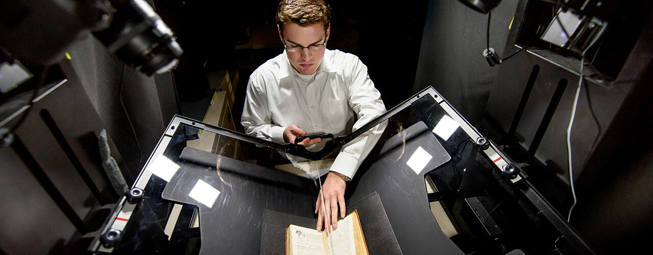 Corey S. scanning archival material.