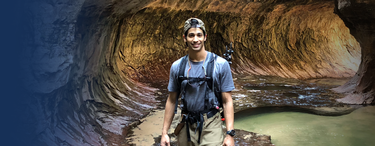 Ermias Bizuwork spelunking in a cave
