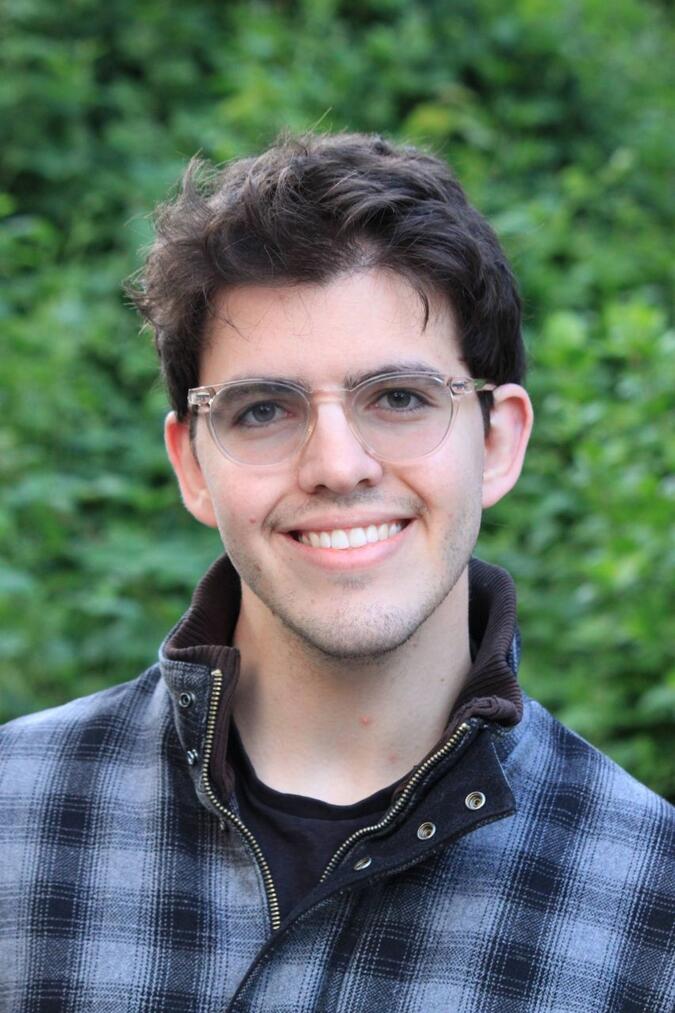 A headshot of Alex Kutsupis