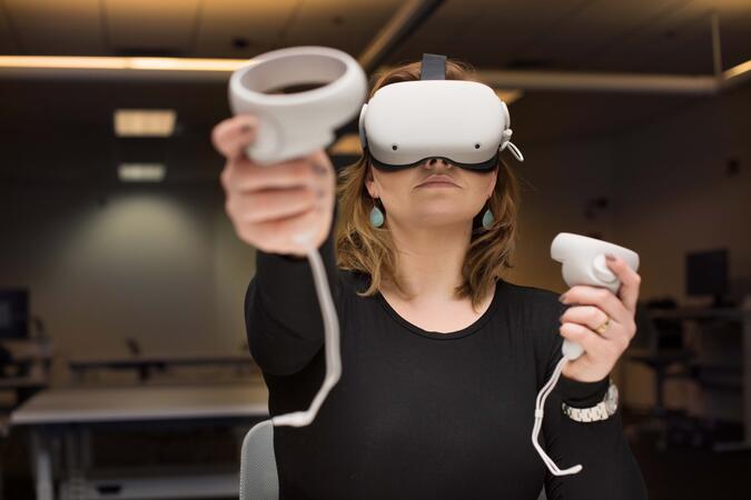 A student using a VR headset in a classroom.
