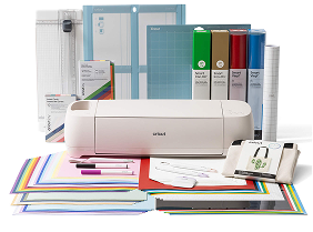 A Cricut machine with all of the accessories around it.