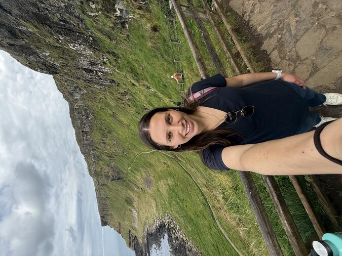 Olivia Lombardo taking a selfie in front of a cliff