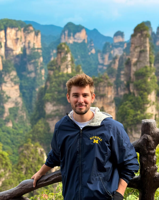 Roger Briddick posing in front of a mountain range