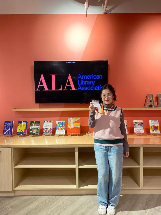 Tina Wen next to a sign that says "ALA: American Library Association."