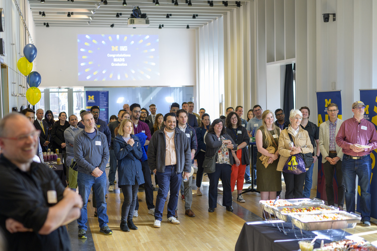 Students mingle in space 2435, a large event space