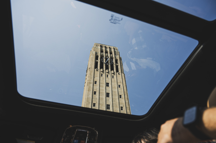 A view of the U-M clocktower through the sun roof of a car