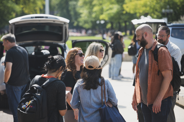 Lecturer Jim Rampton chats with several students during the auto UX showcase