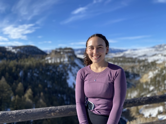 A portrait of Sarah Lancaster with a snow-covered valley behind her