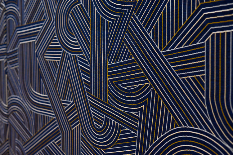 A dark blue wallpaper with an abstract design showing multicolored interconnected lines