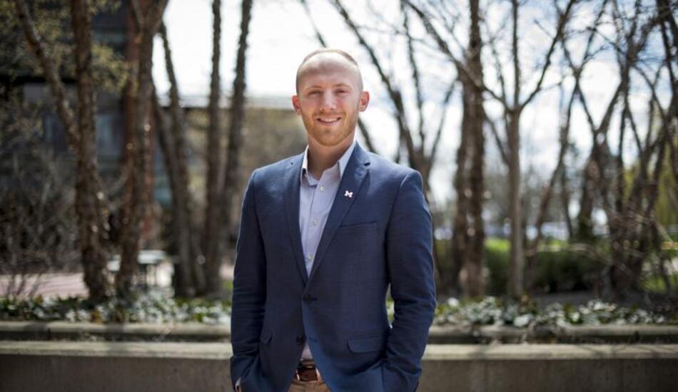 Dane Jacobsen standing outside on campus and smiling.