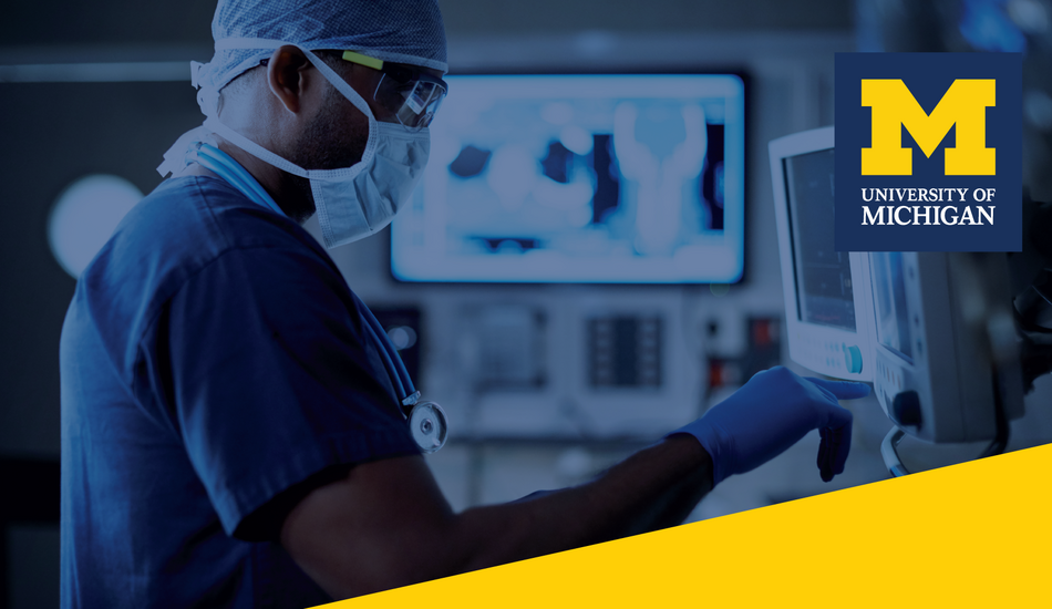 A healthcare professional in scrubs looking at screens