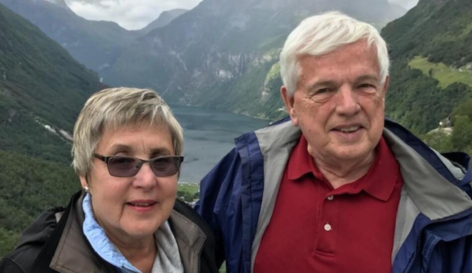 Nancy and Donald Bliss standing near mountains.