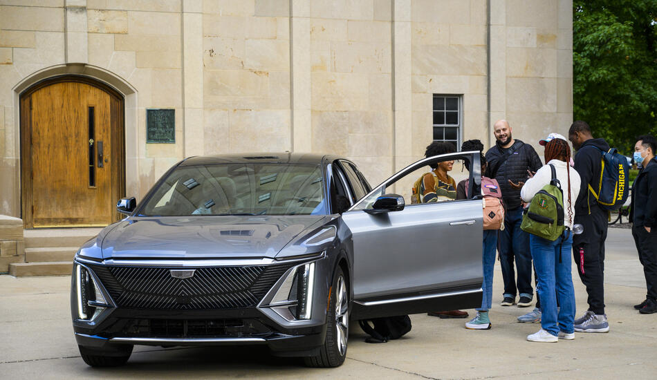 UMSI automotive UX students standing outside of a car.