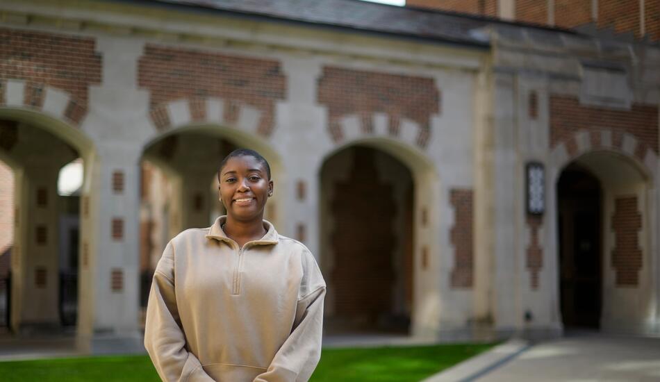 A photo of Tyra Briscoe standing outside of North Quad. 