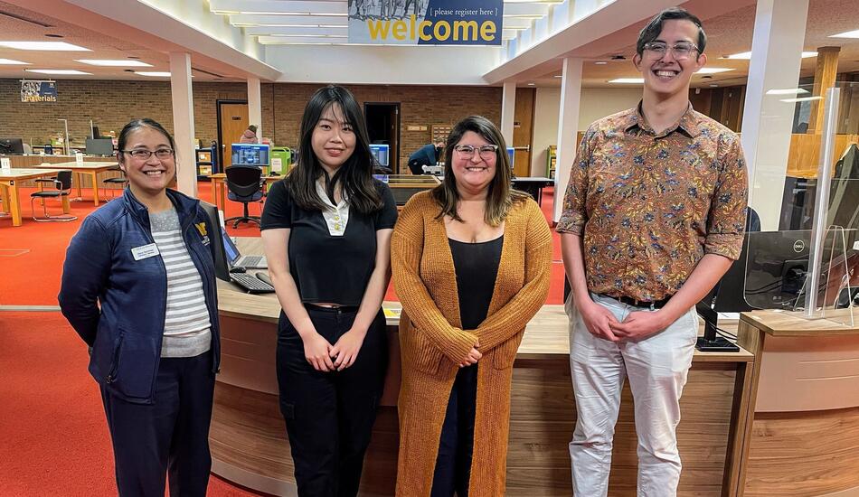 Diana Bachman, assistant director for reference services at the Bentley (MSI '15) stands with Ziyan Zhou (MSI ’24), Stephanie Vettese (MSI ’24) and Clayton Zimmerman (MSI ’25) in front of the library's welcome desk