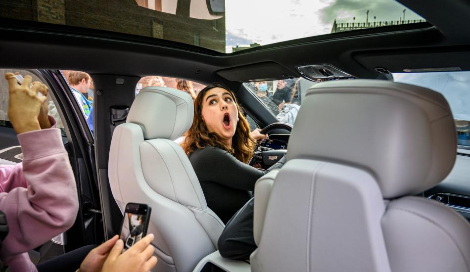 Students in the School of Information Automotive UX design class get a hands-on look at new features in a Cadillac LYRIQ near the UM bell tower
