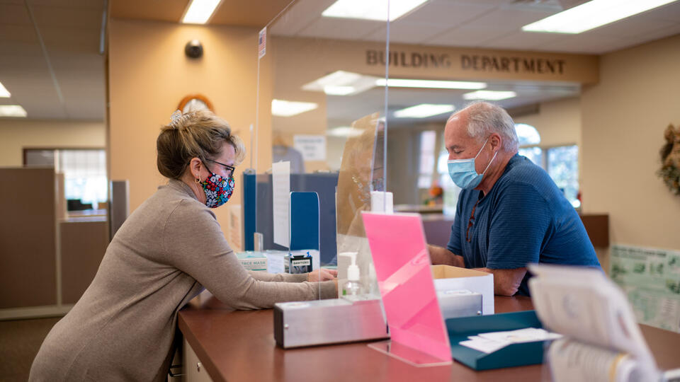 Kelly Richter, the clerk’s office administrative assistant in Oxford Township, assists a resident at the public counter.