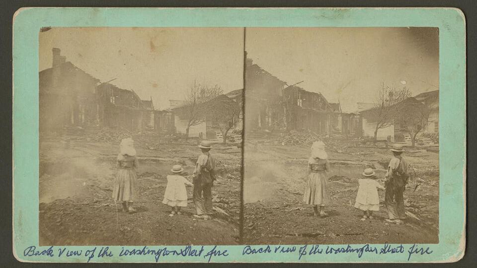 Children stare at the burned remains from the Washington Street fire