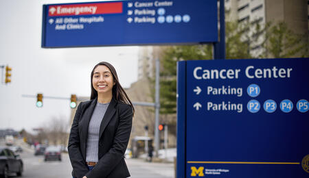 Alexis Villafranca standing in front of Michigan Medicine