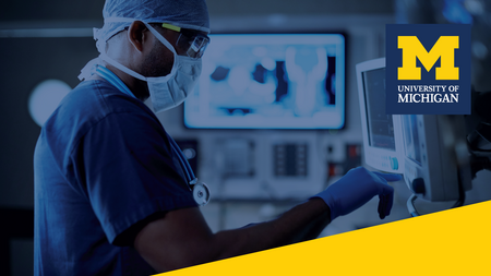 A healthcare professional in scrubs looking at screens