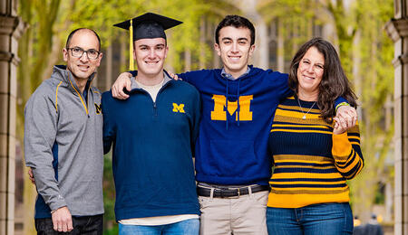 The Ehrenberg family smiling and dressed in U-M colors.