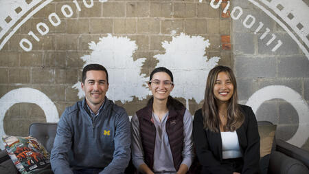 Mike, Sierre and Alice sit on a couch at the Duo headquarters in Ann Arbor