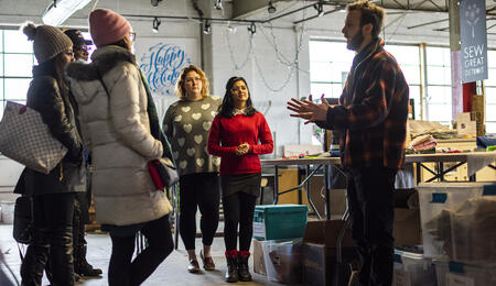 A group of students talking to a client