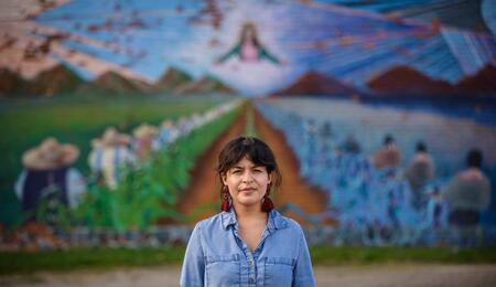 Sylvia Darling standing in front of a mural in Detroit.