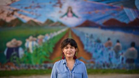 Sylvia Darling standing in front of a mural in Detroit. 