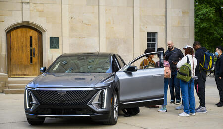 UMSI automotive UX students standing outside of a car.