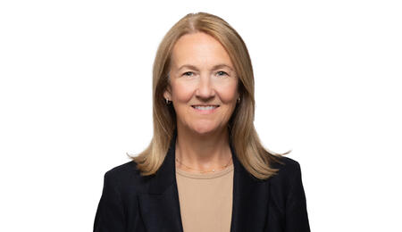 A professional headshot of Stephanie Teasley wearing a black blazer and smiling at the camera. She has blonde hair.