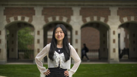 Allison He stands outside of North Quad, posing with her hands on her hips 