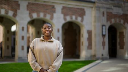A photo of Tyra Briscoe standing outside of North Quad. 