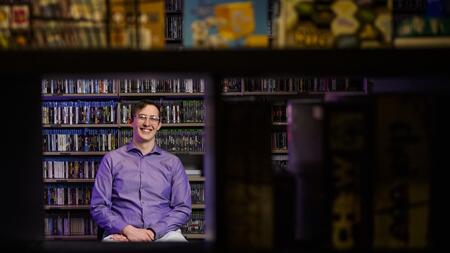 A photo of Clayton Zimmerman among the collection in the Computer and Video Game Archive