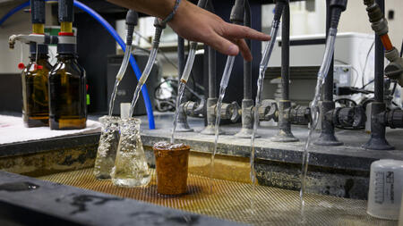 An image of water flowing into beakers at the Ann Arbor Water Treatment Plant