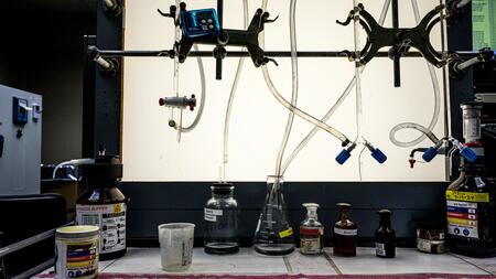 A photo of lab equipment, including tubes, bottles and beakers, used for testing water samples.