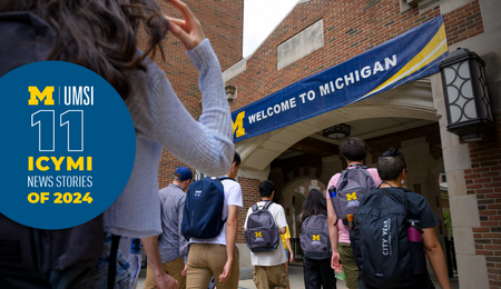 Students walk into brick university building, some wearing UMSI backpacks. Banner on building reads "Welcome to Michigan." Text on image reads "11 ICYMI news stories of 2024."
