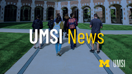 UMSI News. Students walking towards a building. 