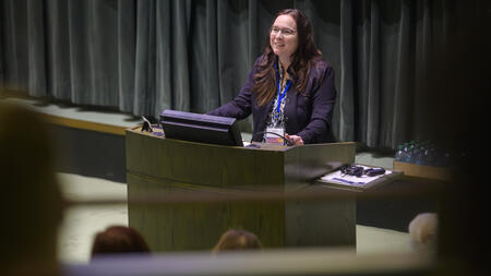 Andrea Forte speaks at a podium